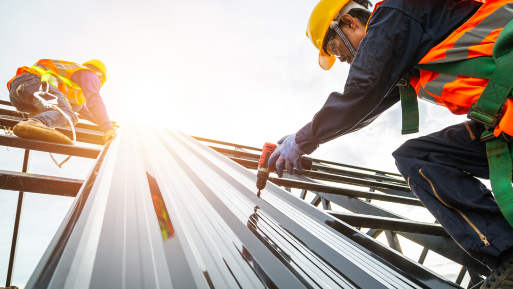 a roofer installing a standing seam roof near spanish fort