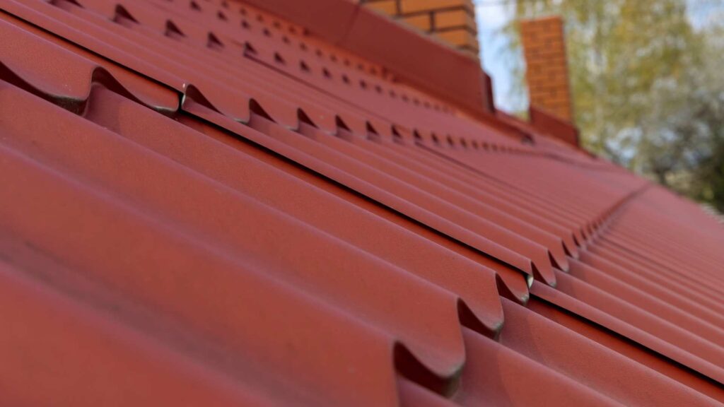 a red metal roof that is durable one of the benefits of metal roofing